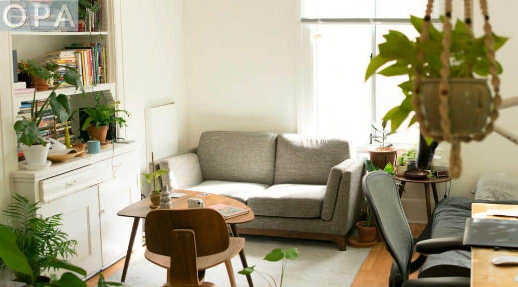 gray fabric loveseat near brown wooden table