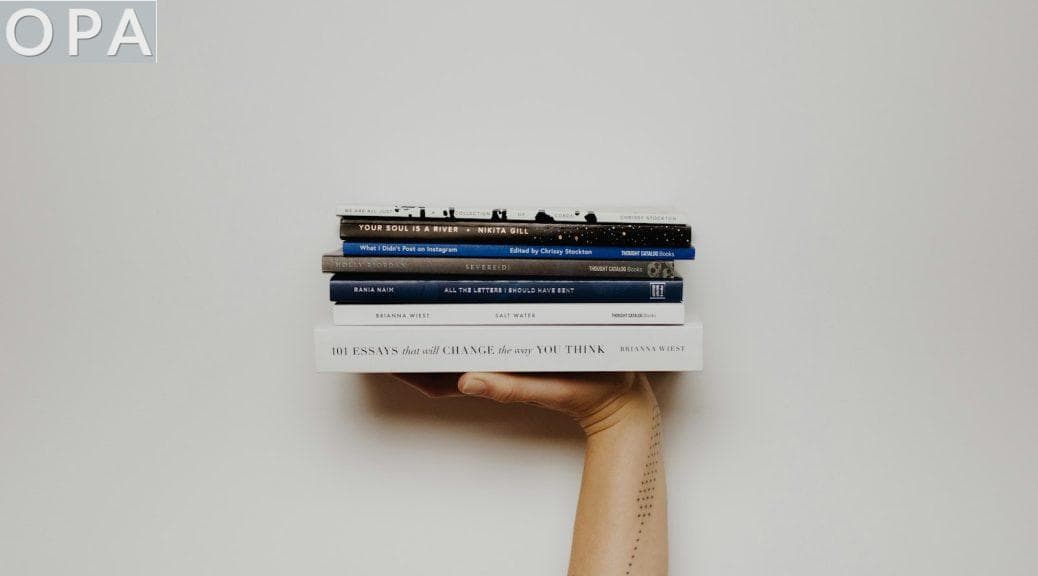 person holding pile of books